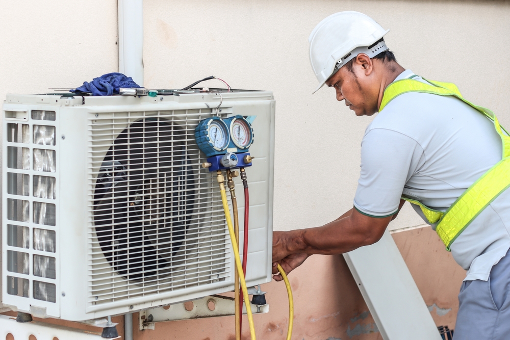 A,Professional,Electrician,Man,Is,Fixing,A,Heavy,Air,Conditioner.