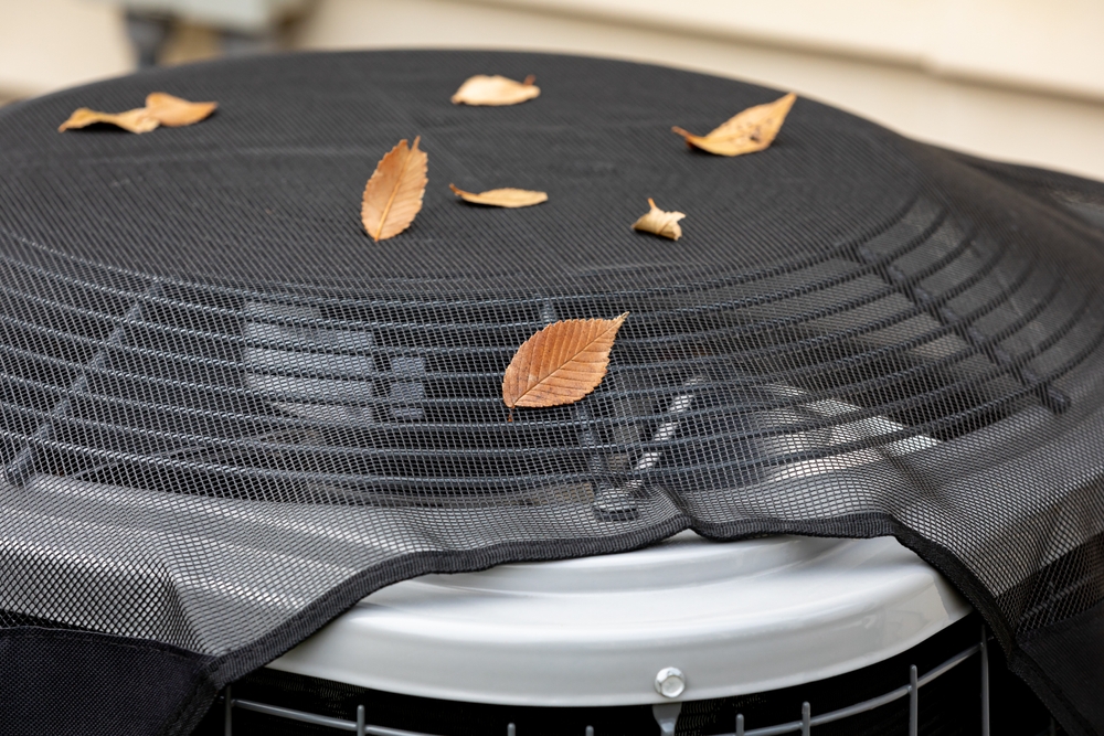 House,Air,Conditioning,Unit,With,Protective,Mesh,Cover,During,Fall